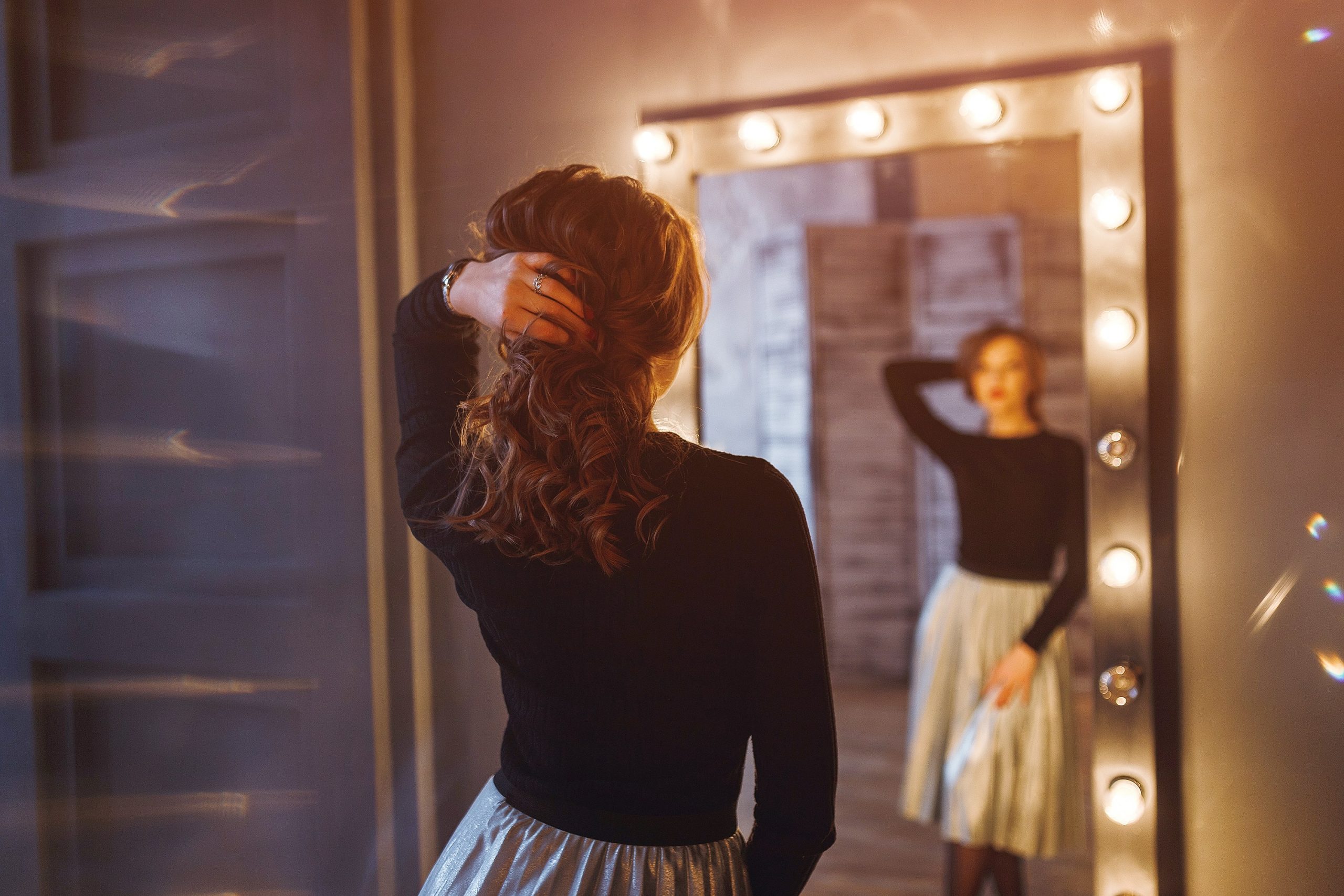 woman looking at herself in a mirror